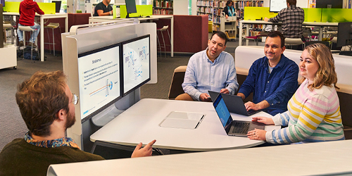 Collaborative discussion among adult students in a library pod setting.