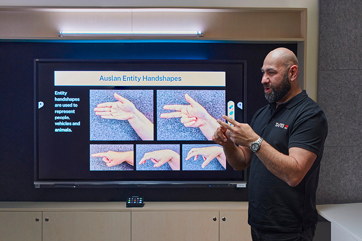 Male teacher teaching Auslan