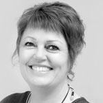 Black and white headshot of Holly Siles, smiling.