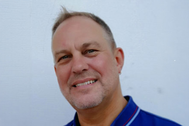 Rod McCrae, Head Teacher of Entertainment Design and Illustration at the TAFE NSW Design Centre, Enmore, is wearing a blue polo shirt and smiling warmly at the camera.