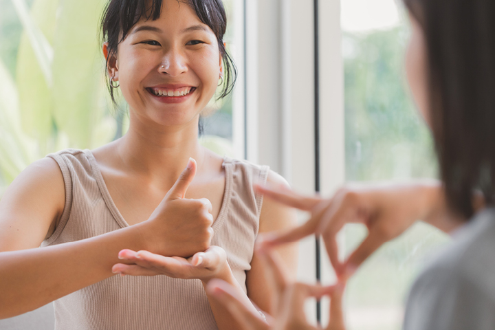 Two people having a sign language session.