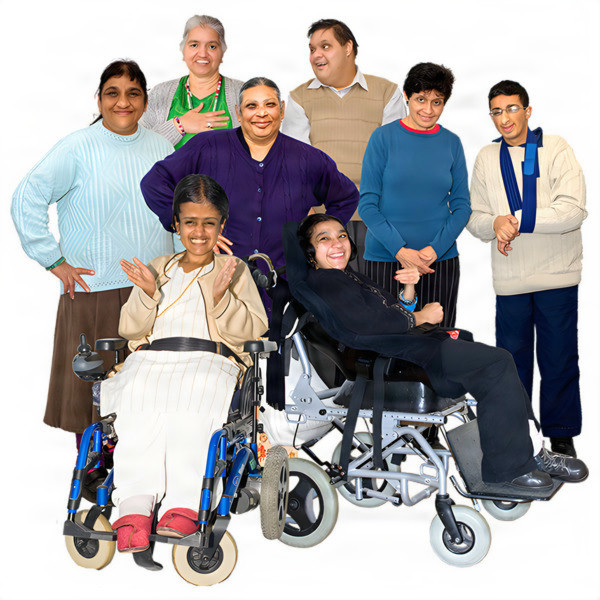 A diverse group of eight people, including two in wheelchairs, smiling and posing together.