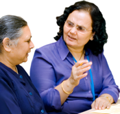 Two women having a conversation at a table.