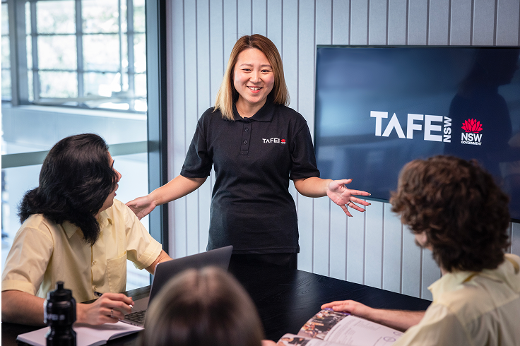 A TAFE NSW staff member talking to a group of students.
