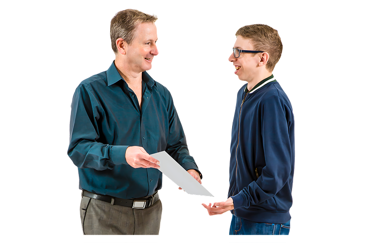 Two men smiling and exchanging a piece of paper.