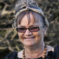 Gamilaraay woman, ‘Aunty Beth’ Wright. smiling at the camera, wearing rectangular sunglasses.