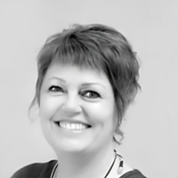 Black and white headshot of Holly Siles, smiling.