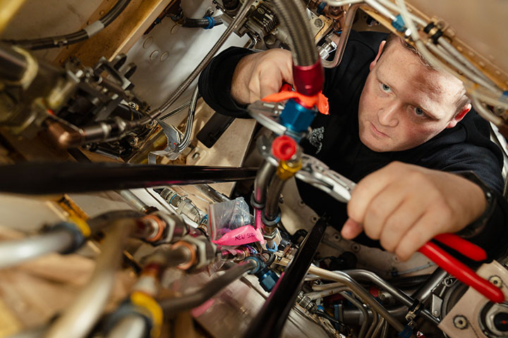 Ben Nordsvan is looking deep in concentration as he works on complex helicopter components
