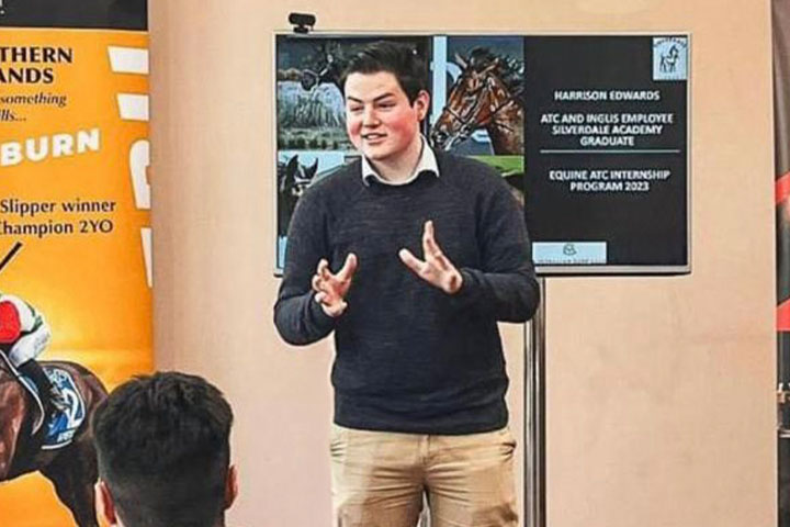 TAFE NSW graduate Harrison Edward giving a presentation to a room of people
